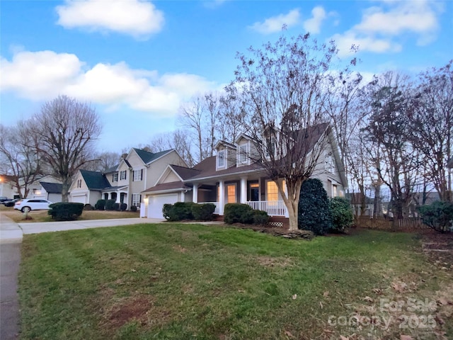 view of front facade featuring a garage, a front yard, and a porch