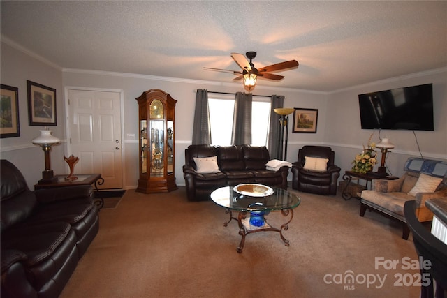 carpeted living room with ornamental molding, ceiling fan, and a textured ceiling