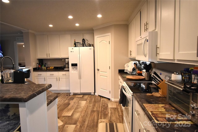 kitchen with crown molding, white appliances, light hardwood / wood-style flooring, and white cabinets