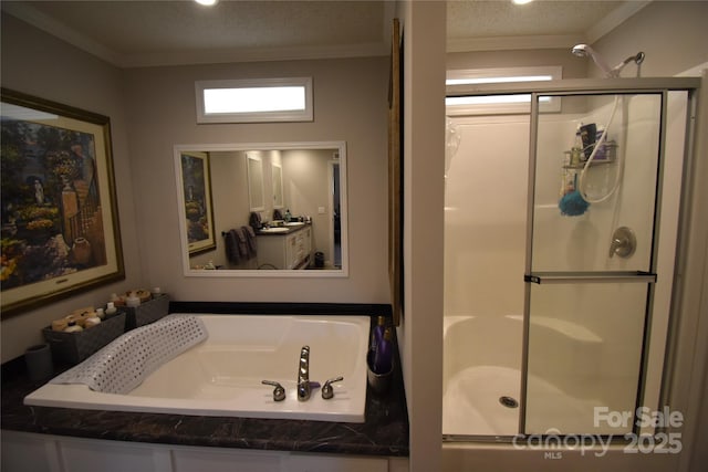 bathroom featuring ornamental molding, a textured ceiling, and separate shower and tub