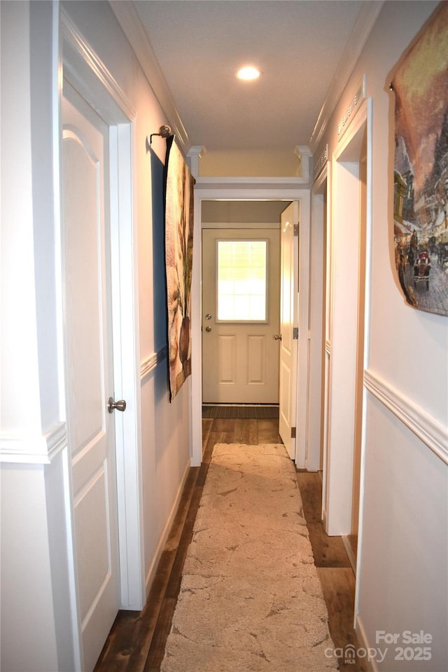 hall featuring ornamental molding and dark wood-style floors