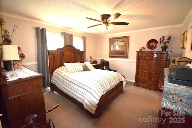 bedroom featuring ceiling fan, a textured ceiling, ornamental molding, and carpet floors