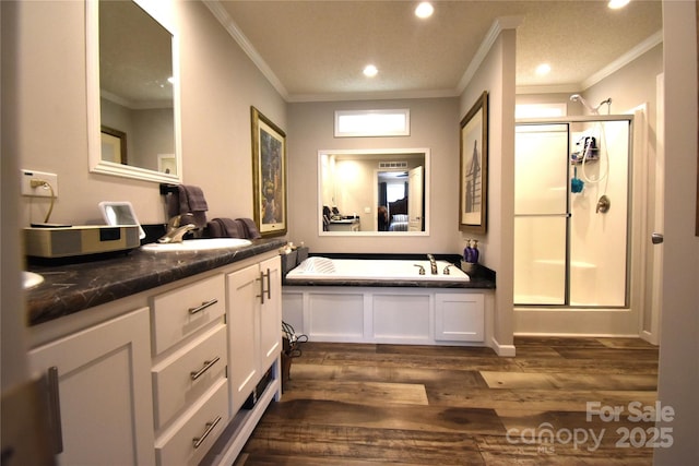 bathroom with a shower stall, ornamental molding, and wood finished floors