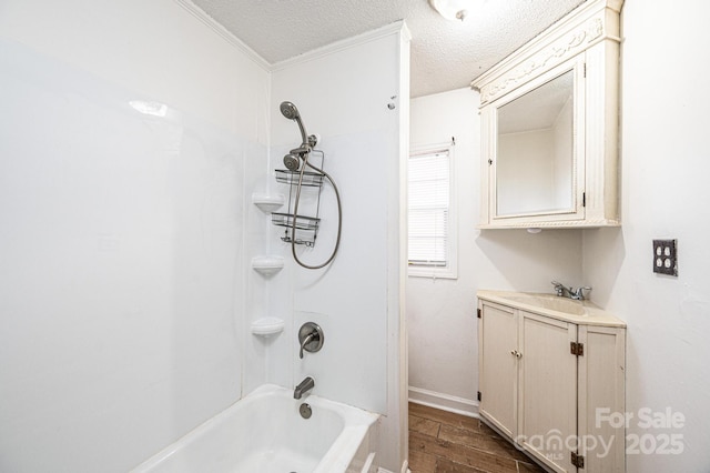 bathroom featuring vanity, wood-type flooring, bathing tub / shower combination, and a textured ceiling