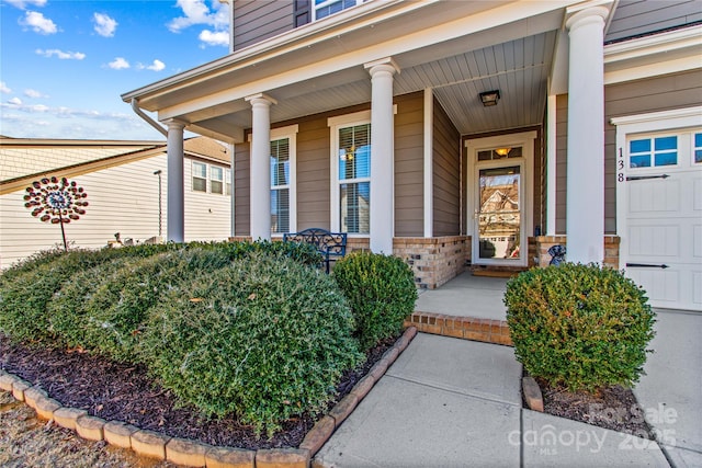 property entrance with a garage and covered porch