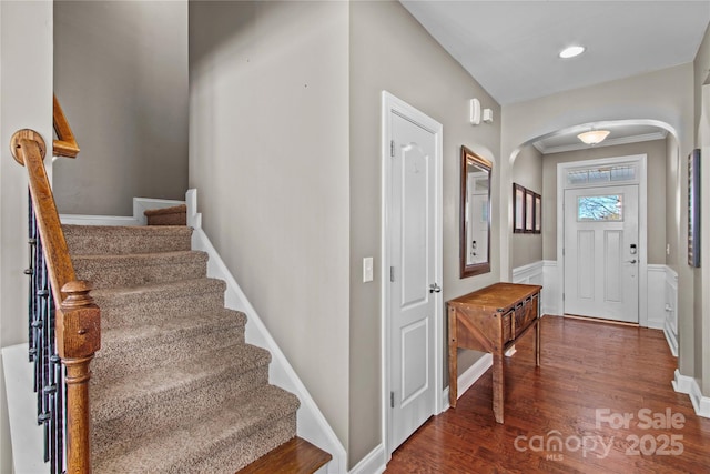 entryway with crown molding and dark hardwood / wood-style floors