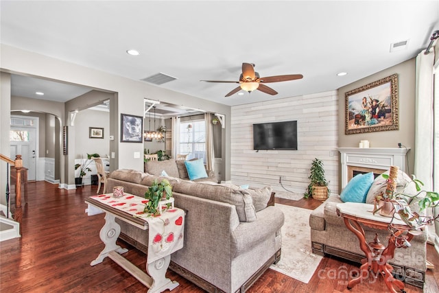 living room featuring dark hardwood / wood-style floors and ceiling fan