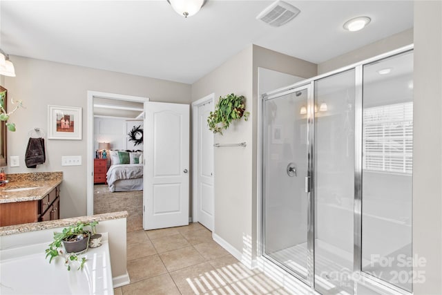 bathroom featuring an enclosed shower, vanity, and tile patterned floors