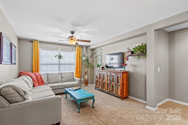 living room featuring light carpet and ceiling fan