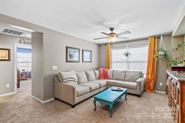 carpeted living room with ceiling fan