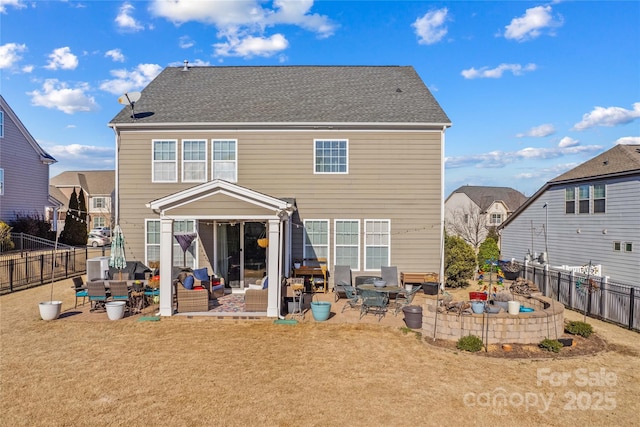 back of property with outdoor lounge area, a patio, and a lawn