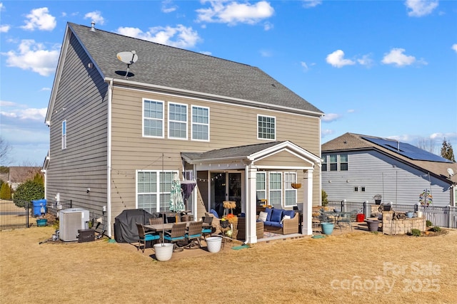 back of property with an outdoor living space, a yard, central AC unit, and a patio area