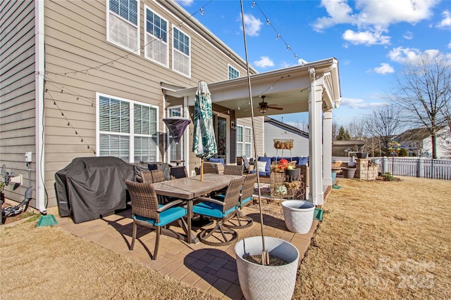 rear view of house featuring ceiling fan, an outdoor hangout area, a patio, and a lawn