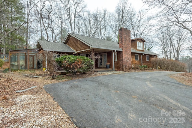 view of front of home featuring a sunroom