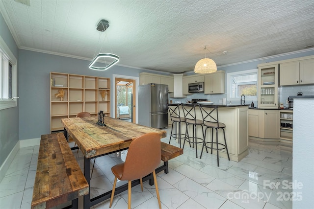 dining area featuring crown molding