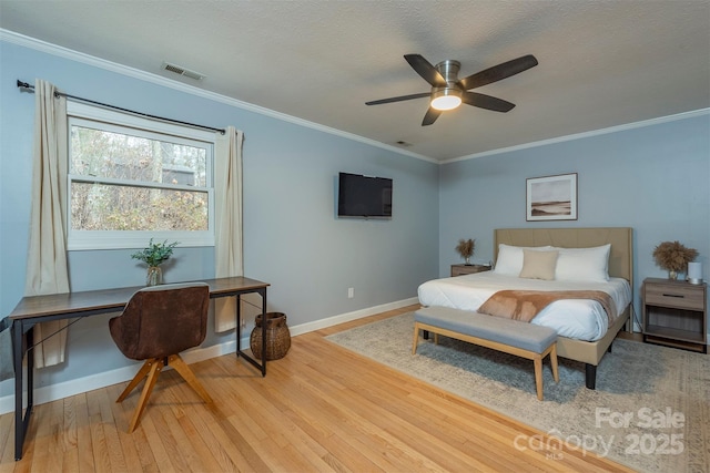 bedroom with ceiling fan, light hardwood / wood-style flooring, ornamental molding, and a textured ceiling