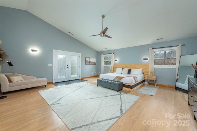 bedroom featuring high vaulted ceiling, access to outside, ceiling fan, light hardwood / wood-style floors, and french doors