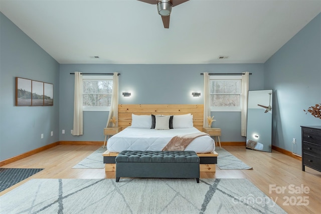 bedroom with ceiling fan, lofted ceiling, and light hardwood / wood-style floors