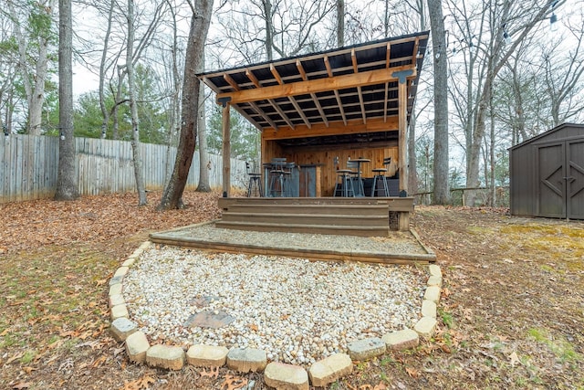 exterior space featuring a wooden deck and a storage unit