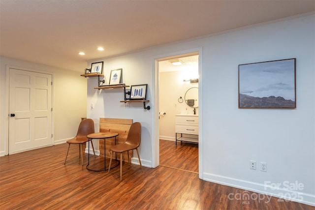 sitting room featuring dark hardwood / wood-style flooring and crown molding