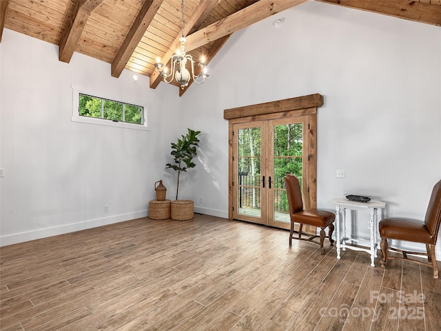 unfurnished room featuring an inviting chandelier, hardwood / wood-style floors, wood ceiling, and beam ceiling