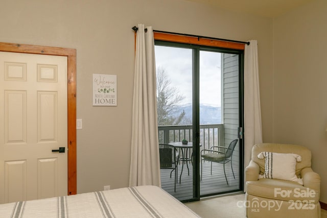 bedroom with a mountain view and access to outside