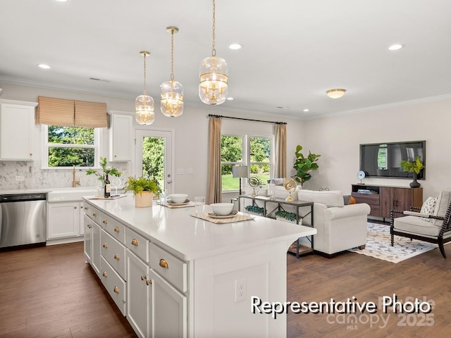 kitchen with dishwasher, hanging light fixtures, a kitchen island, and white cabinets