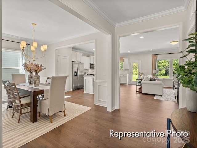 dining room featuring crown molding, dark hardwood / wood-style flooring, and a notable chandelier