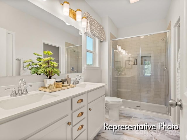 bathroom featuring vanity, an enclosed shower, and toilet