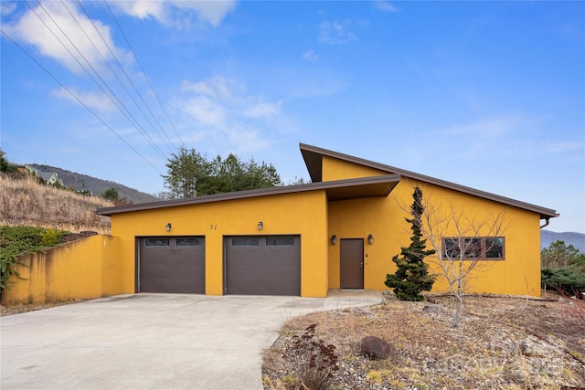 contemporary home with a garage and a mountain view