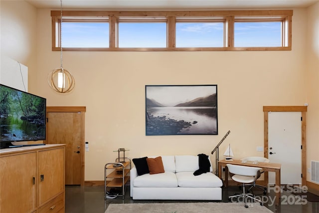 living room featuring a towering ceiling