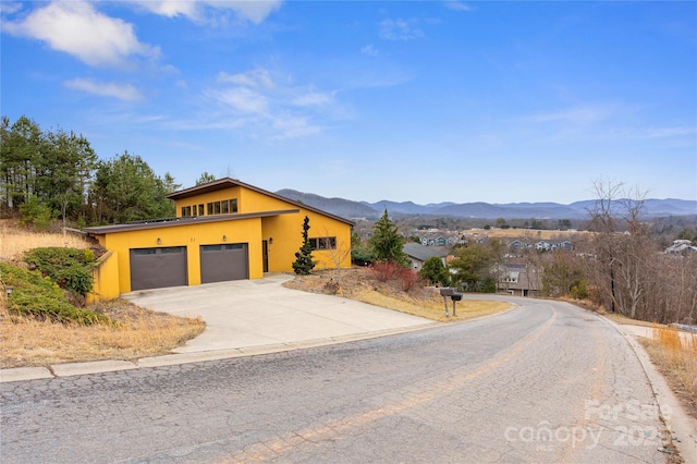 view of front of home featuring a garage and a mountain view