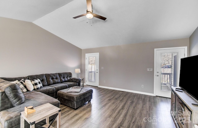 living room featuring a healthy amount of sunlight, lofted ceiling, and hardwood / wood-style floors