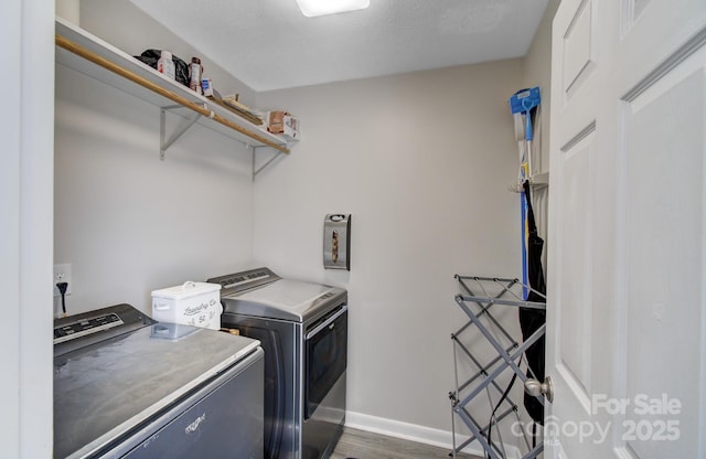 laundry area featuring separate washer and dryer and dark wood-type flooring