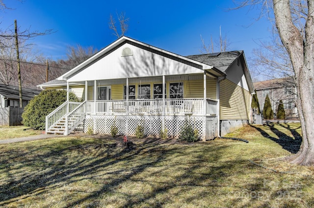 view of front facade with a front yard and covered porch