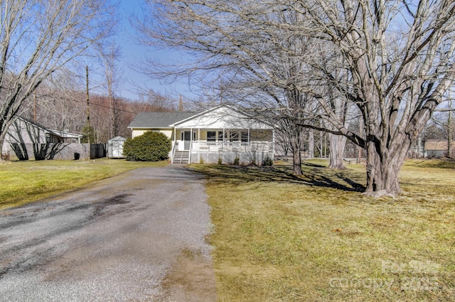 ranch-style house with a front lawn and a porch