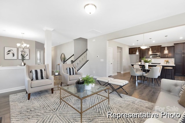 living room featuring dark wood-type flooring and a notable chandelier