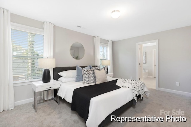 carpeted bedroom featuring ensuite bathroom