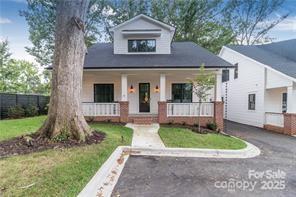 view of front of home featuring covered porch and a front lawn