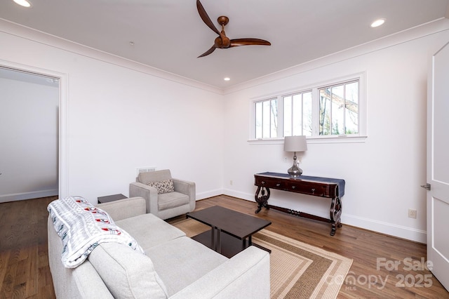 living room with ornamental molding, recessed lighting, baseboards, and wood finished floors