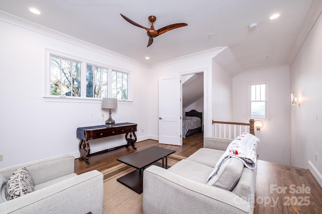 living room with ornamental molding, recessed lighting, and wood finished floors