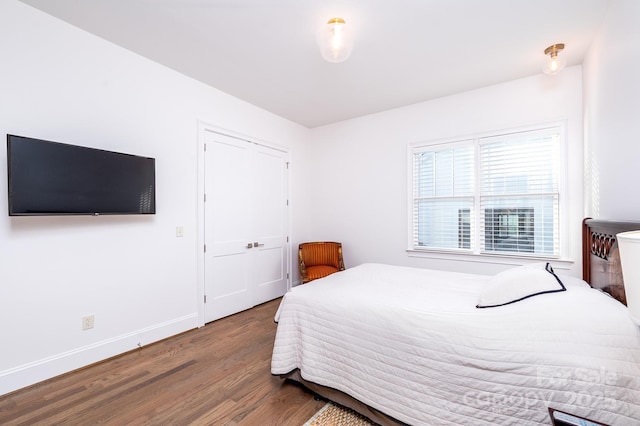 bedroom with baseboards and wood finished floors