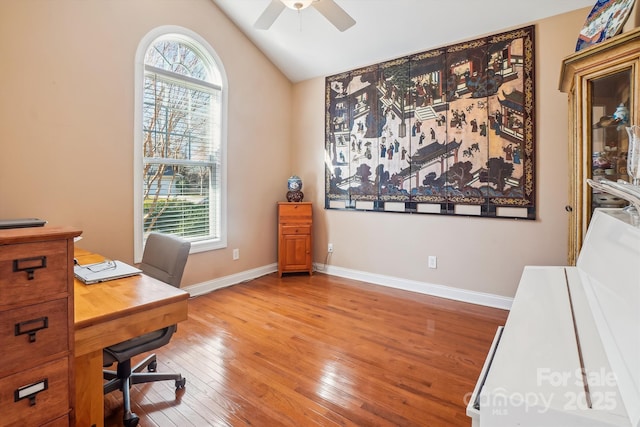 home office featuring vaulted ceiling, ceiling fan, and light hardwood / wood-style floors