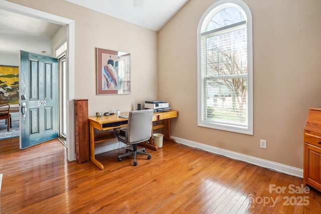 office area featuring vaulted ceiling and light hardwood / wood-style floors