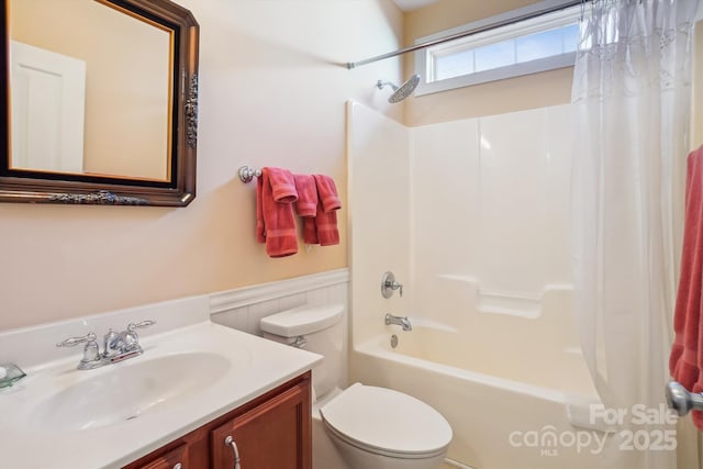 full bathroom with vanity, shower / tub combo, and toilet