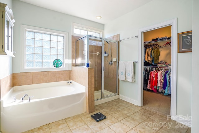 bathroom with tile patterned flooring and separate shower and tub