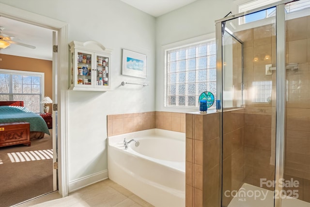 bathroom featuring separate shower and tub and ceiling fan