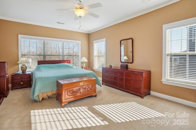 carpeted bedroom with crown molding and ceiling fan