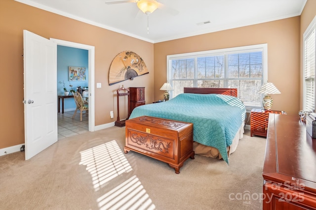 carpeted bedroom featuring multiple windows, ornamental molding, and ceiling fan