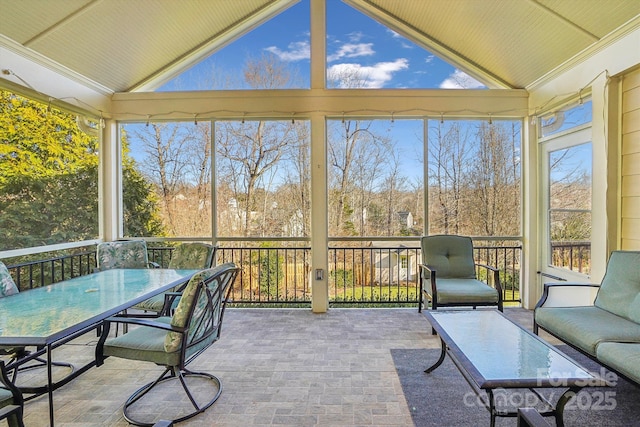 unfurnished sunroom with lofted ceiling